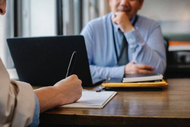 people at table completing screening interview